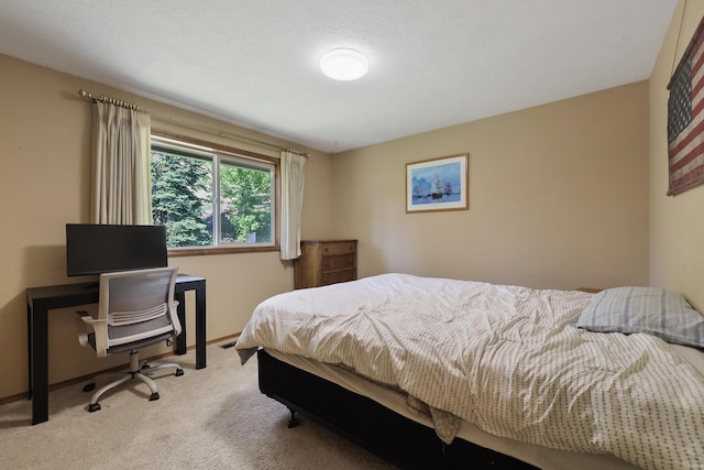 bedroom featuring light carpet