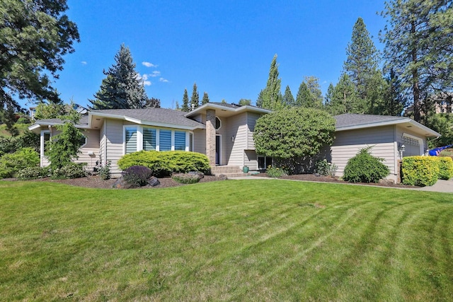 view of front of property with a garage and a front lawn