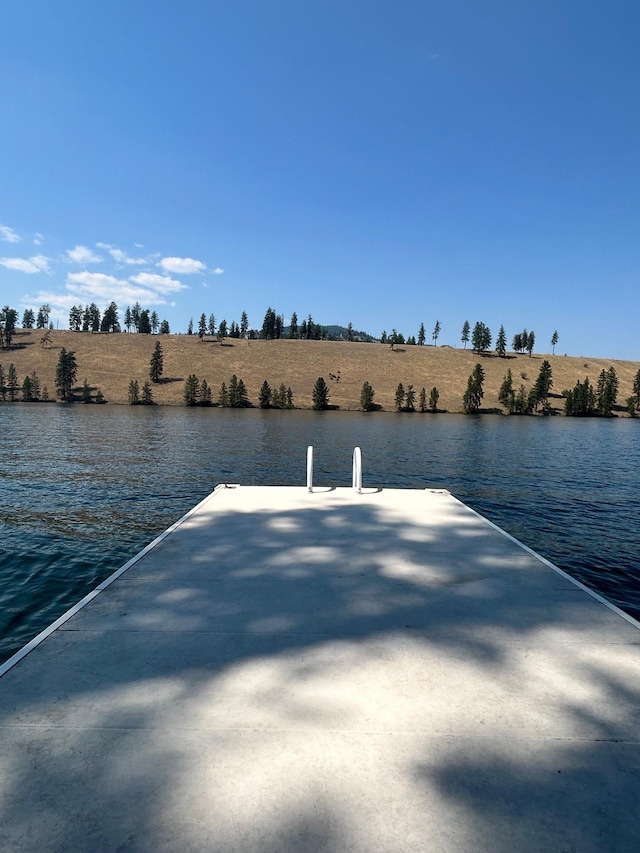 dock area with a water view and a rural view