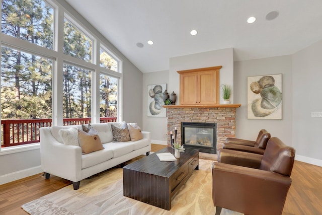 living room featuring high vaulted ceiling and light wood-type flooring