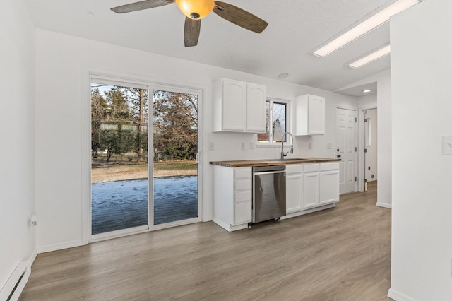 kitchen featuring butcher block counters, sink, a baseboard radiator, dishwasher, and white cabinets