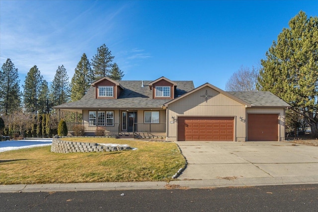 view of front of property featuring a garage, a porch, and a front lawn