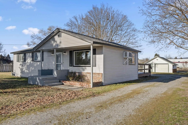 view of front of house featuring an outbuilding, a garage, and a wall mounted AC