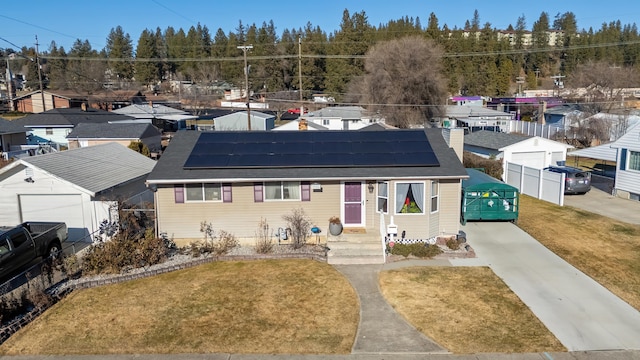 view of front facade with a front yard and solar panels