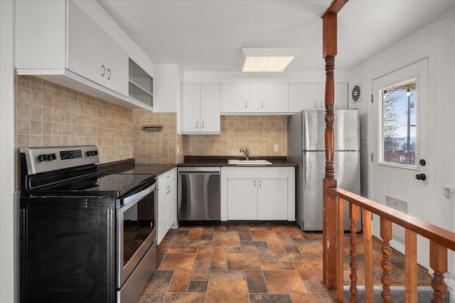 kitchen with white cabinetry, appliances with stainless steel finishes, sink, and backsplash