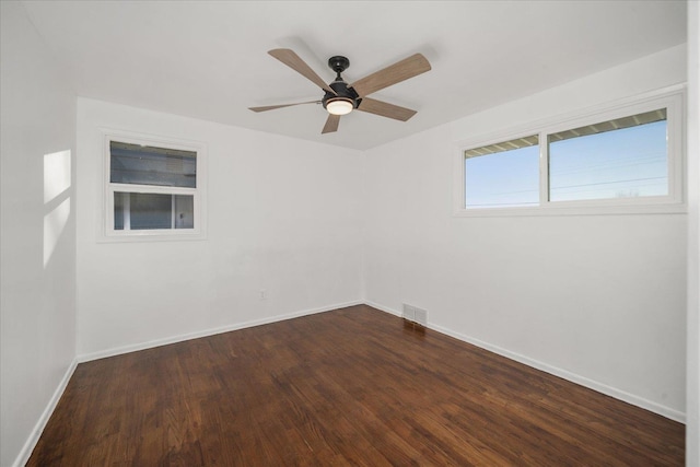 spare room with ceiling fan and dark hardwood / wood-style flooring