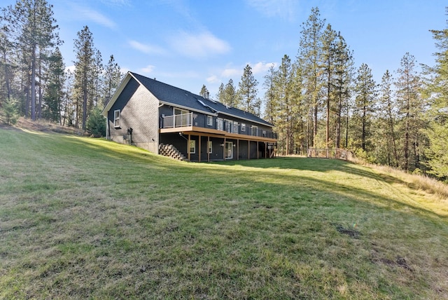 exterior space with a wooden deck and a lawn