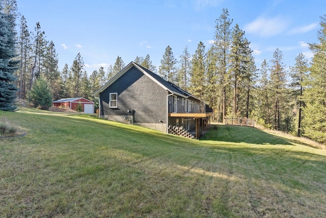 view of home's exterior featuring a garage, a wooden deck, and a lawn