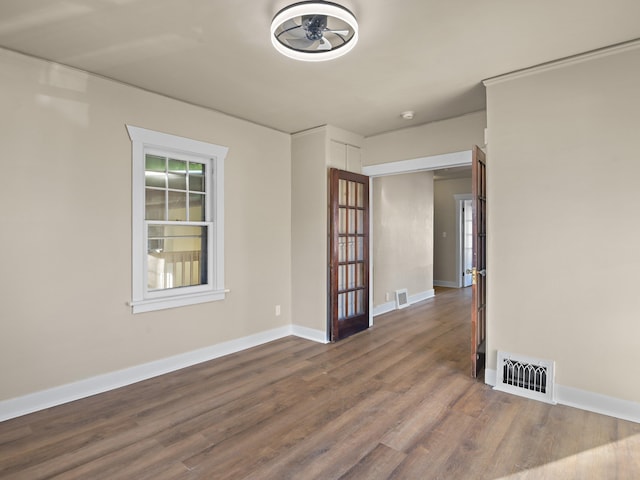 unfurnished room with wood-type flooring