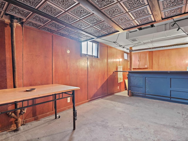 basement featuring wood walls