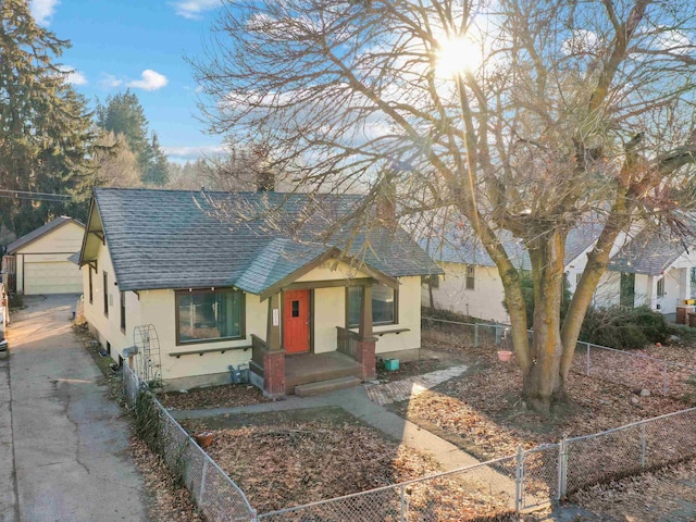 view of front of house with a garage and an outdoor structure