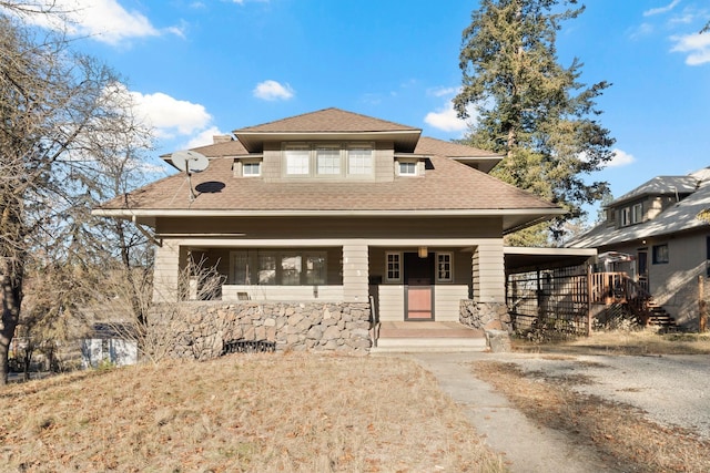 view of front of home with a garage and a carport