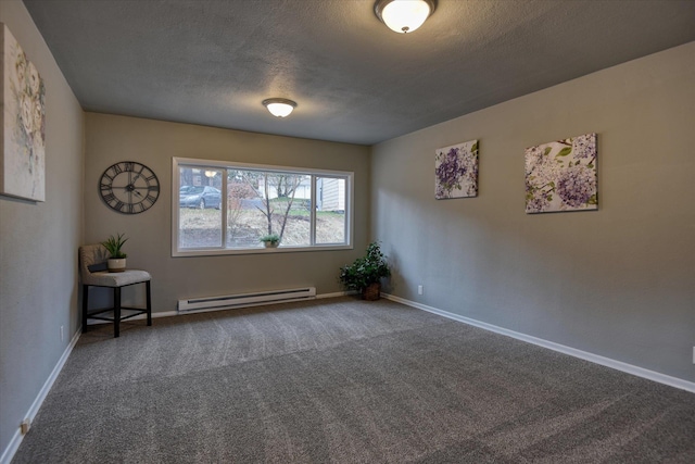 carpeted spare room featuring a baseboard heating unit, a textured ceiling, and baseboards