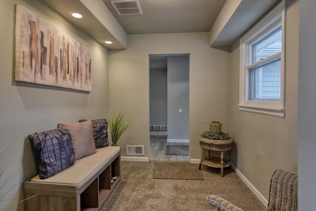 interior space with carpet floors, recessed lighting, visible vents, and baseboards