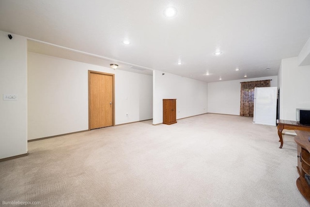 unfurnished living room featuring light carpet