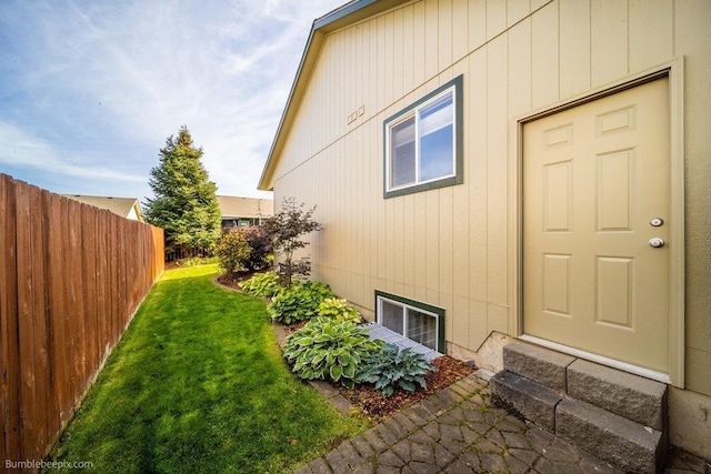 view of side of home featuring a yard