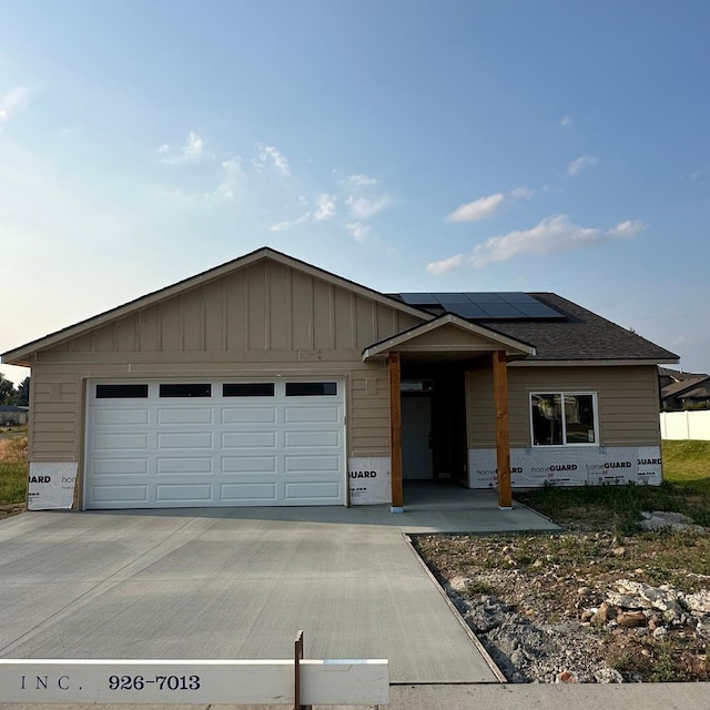 17811 E Nora Ave, Spokane Valley, WA 99016 - view of front of property with roof mounted solar panels and a garage