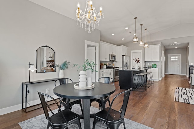 dining area with vaulted ceiling and dark hardwood / wood-style flooring