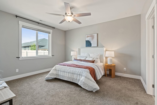 bedroom featuring a mountain view, carpet floors, and ceiling fan