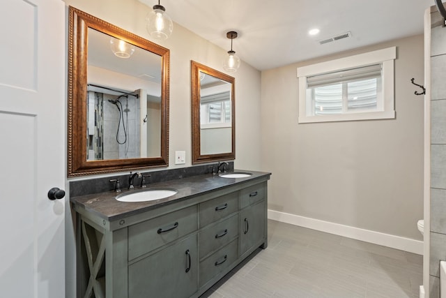 bathroom featuring vanity, a shower, and toilet