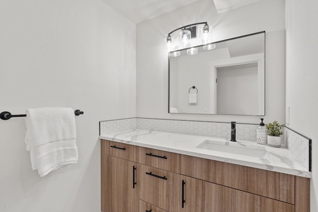 bathroom featuring vanity and backsplash