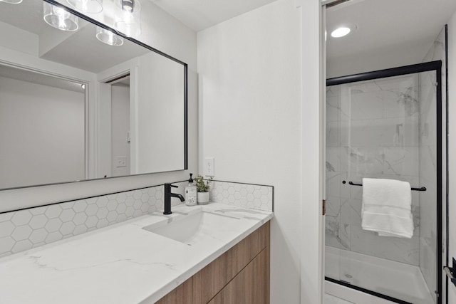 bathroom with vanity, backsplash, and walk in shower