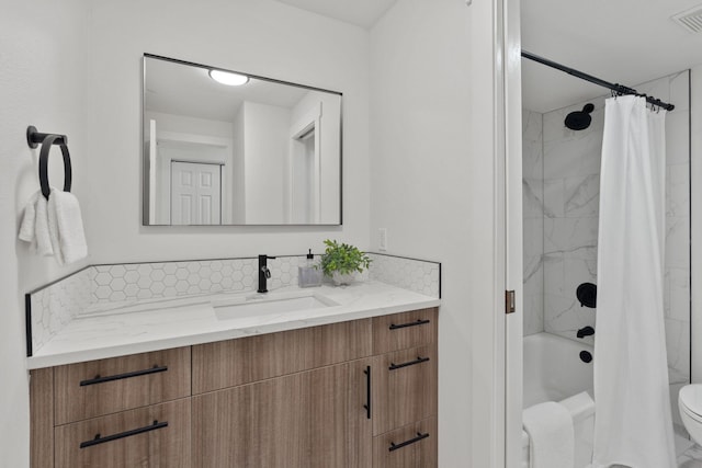 full bathroom featuring toilet, vanity, and shower / bathtub combination with curtain