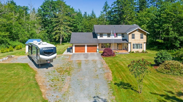 view of front of home featuring a porch, a garage, and a front yard