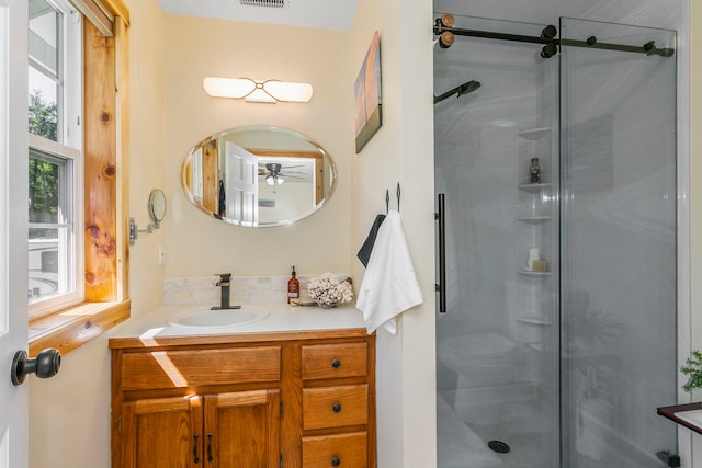 bathroom featuring vanity and a shower with shower door