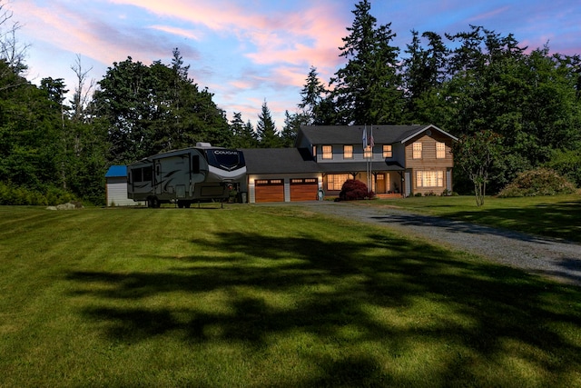 view of front of house featuring a garage and a lawn