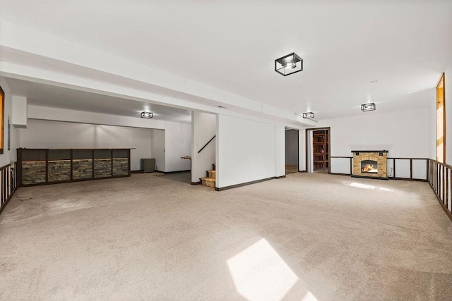 interior space with light carpet and a fireplace