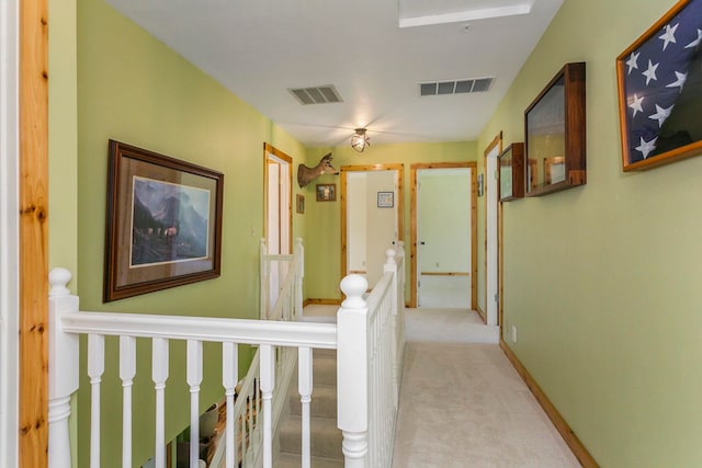 hallway featuring light colored carpet