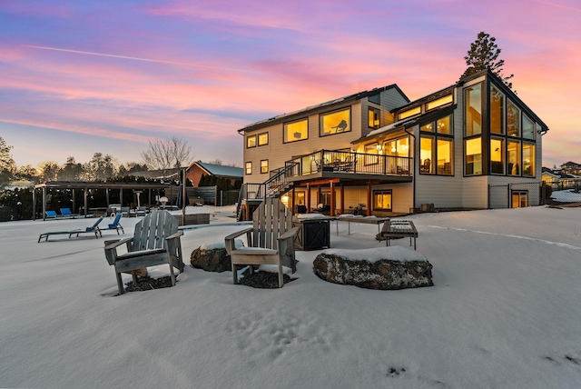 back house at dusk with a deck