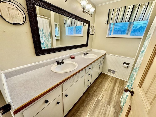 bathroom with hardwood / wood-style flooring, vanity, and ornamental molding