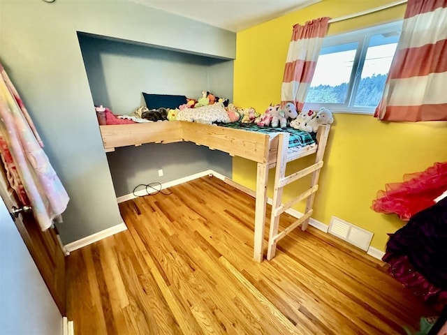 bedroom with hardwood / wood-style flooring