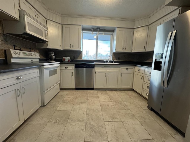 kitchen with appliances with stainless steel finishes, tasteful backsplash, sink, ornamental molding, and a textured ceiling