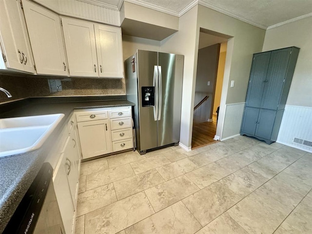 kitchen with crown molding, appliances with stainless steel finishes, sink, and white cabinets