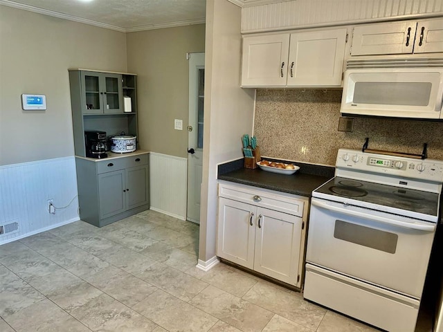 kitchen featuring crown molding, white appliances, decorative backsplash, and white cabinets