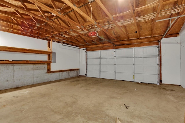 garage featuring a garage door opener and electric panel