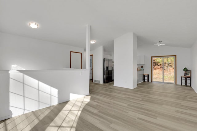 empty room with lofted ceiling and light hardwood / wood-style flooring