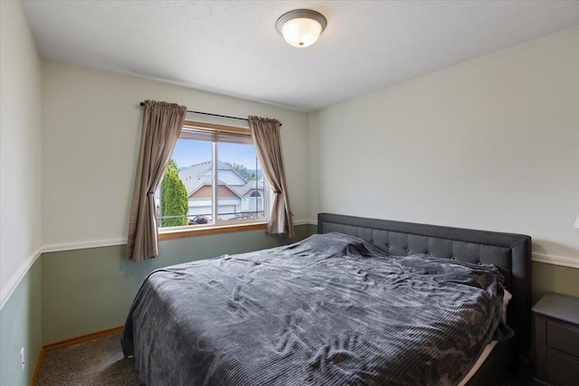 carpeted bedroom featuring a textured ceiling