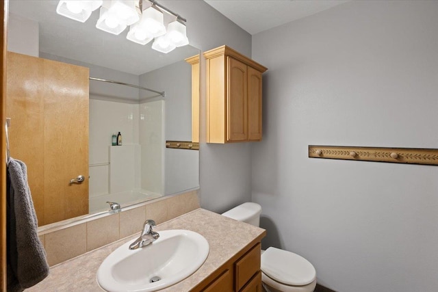 bathroom featuring walk in shower, vanity, and toilet