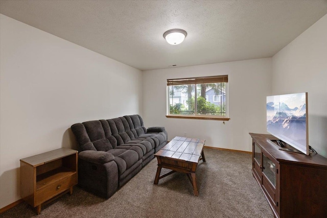 living room featuring dark carpet and a textured ceiling