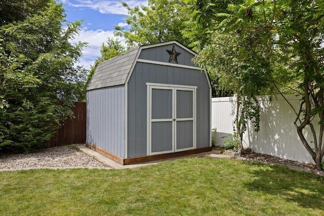 view of outdoor structure featuring a lawn