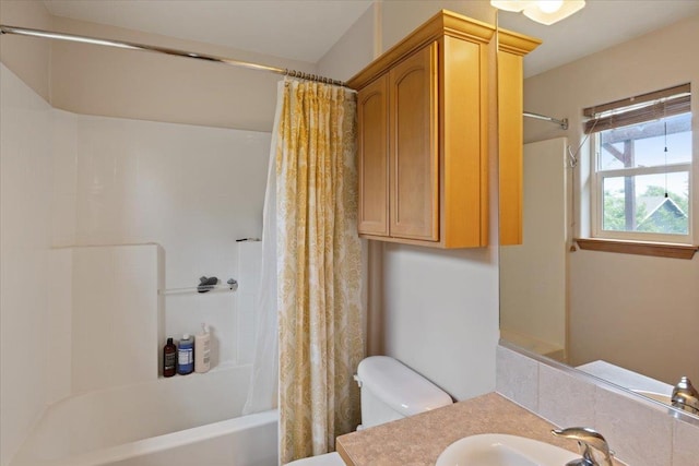 full bathroom with vanity, shower / bath combo, and toilet