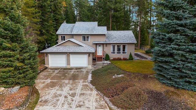 split level home with a garage and a front yard