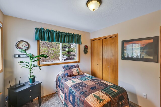 bedroom with carpet and a closet