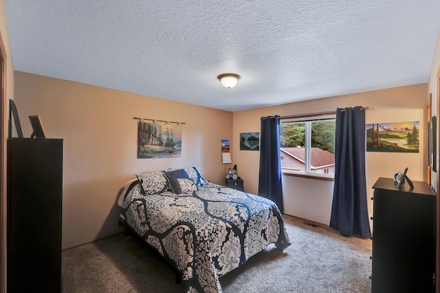 carpeted bedroom featuring a textured ceiling