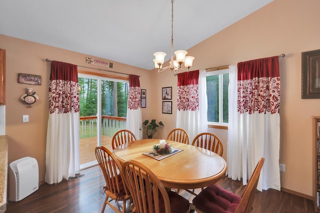 dining room with dark wood-type flooring, a chandelier, and vaulted ceiling