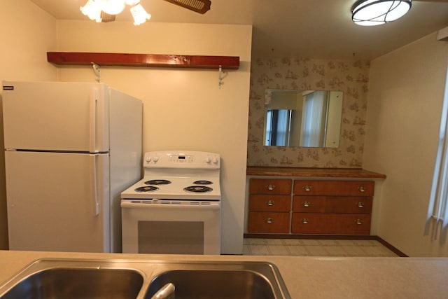 kitchen featuring sink, white appliances, and ceiling fan